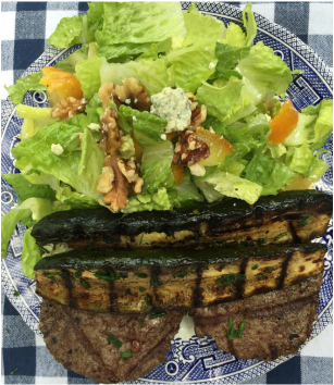 A typical low-carbohydrate, high-fat meal eaten by Dr. Gorczynski. It consists of grass-fed meat, grilled zucchini with added olive oil and a green salad with nuts and cheese.