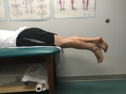 Dr. Gorczynski demonstrates prone hang technique to regain knee extension